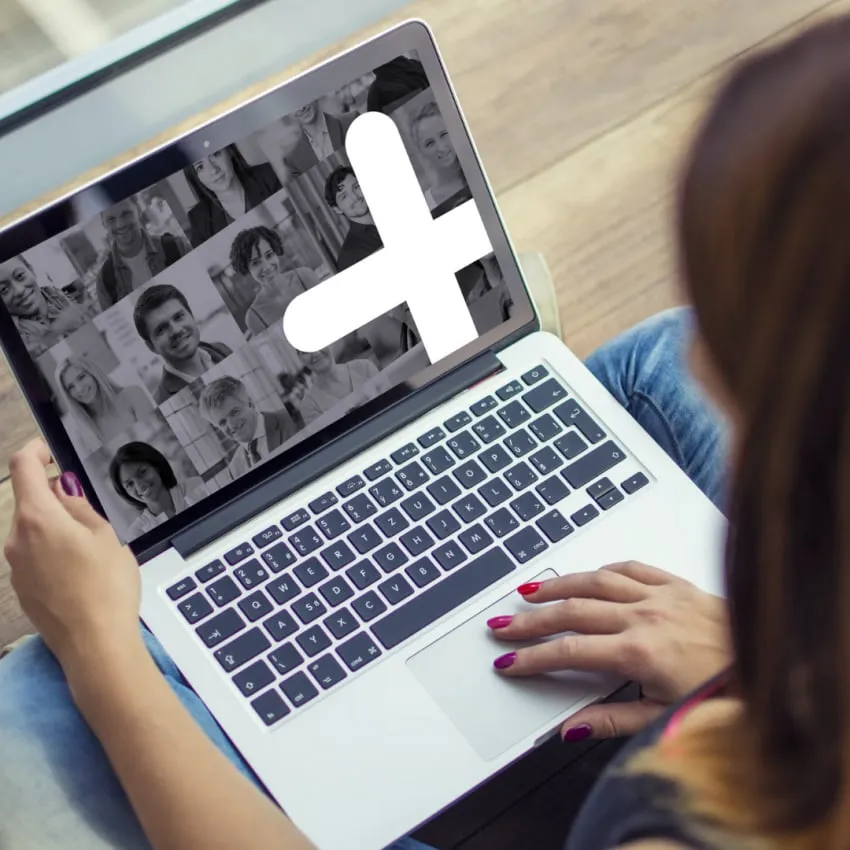 A laptop showing a grid of attendee photos behind the Tavata plus mark