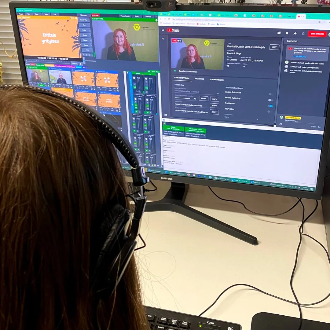 A stream operator wearing headphones monitoring an event live stream on two screens