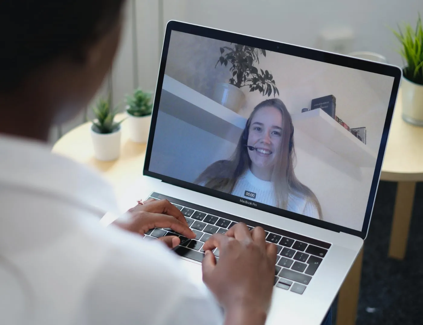 A person in a Tavata video meeting with another attendee on a laptop screen