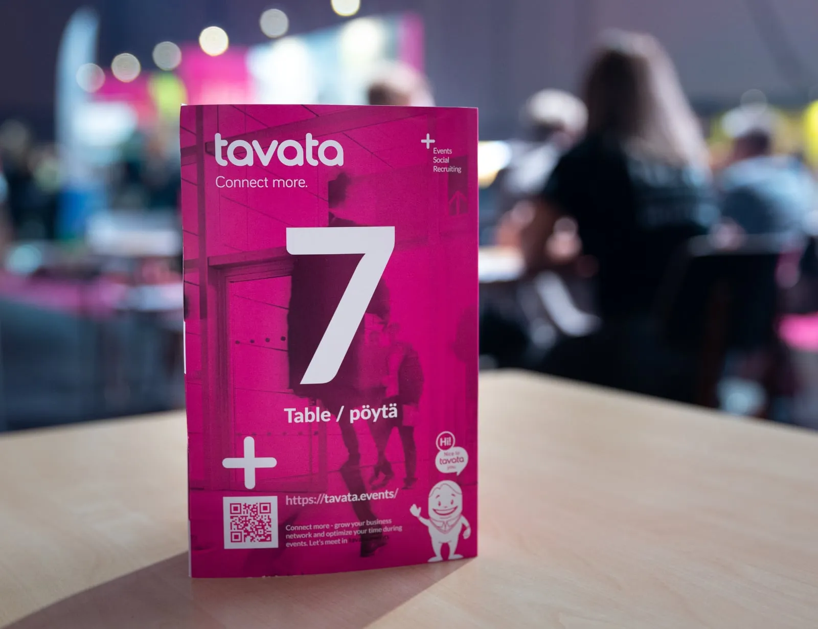 A Tavata table card numbered 7 marking a meeting table at an event