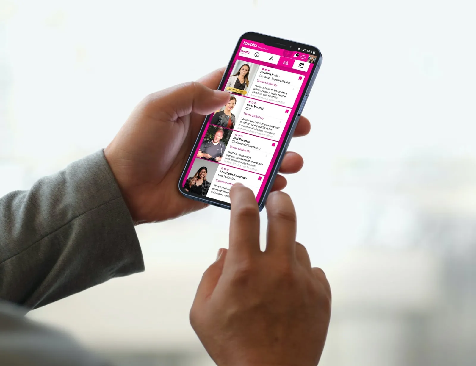 A phone showing the Tavata attendee list with profile cards