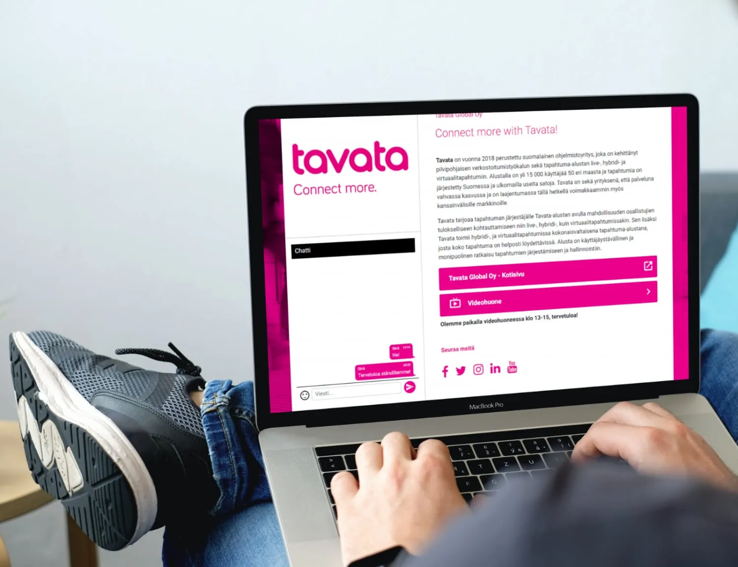 A laptop showing a Tavata virtual booth with the company’s info, video room and chat
